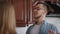 Portrait of excited smiling handsome man in eyeglasses talking with woman in kitchen at home. Positive Caucasian