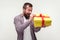 Portrait of excited surprised bearded man unpacking big present, looking amazed pleasantly surprised. white background