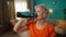 Portrait of an exhausted but satisfied grayhaired elderly woman after a workout in the living room. Tired elderly woman