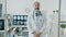 Portrait of experienced male doctor wearing white gown standing in clinic office