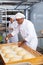 Portrait of experienced professional baker during daily work in kitchen of bakeshop