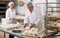 Portrait of experienced professional baker during daily work in kitchen of small bakeshop