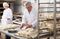 Portrait of experienced professional baker during daily work in kitchen of small bakeshop