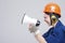 Portrait of Expressive Caucasian Female With Loudspeaker Horn Posing In Hardhat