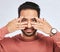 Portrait, eyes and asian man with fingers on face in studio with confidence, personality and persona on grey background