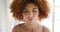 Portrait of the face and head of a woman with an afro standing alone. Closeup headshot of a redhead feeling content