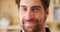 Portrait, face and smile of a handsome man for happiness, hope and positivity standing in a room. Closeup of a friendly