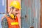 Portrait of factory worker man in hard hat and safety vest, Engineer man with containers box background at cargo