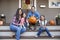 Portrait Of Family Carving Halloween Pumpkin On House Steps