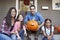 Portrait Of Family Carving Halloween Pumpkin On House Steps
