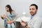 Portrait of family Doctor with stethoscope at his office. Mother and funny happy son on the background