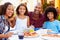 Portrait Of Family Eating Meal At Outdoor Restaurant