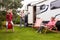 Portrait Of Family Enjoying Camping Holiday In Camper Van