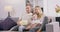 Portrait of a family of four watching tv in living room