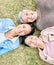 Portrait, family and mother, grandmother and adult daughter relax on grass, happy and bonding in a garden. Face