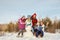 Portrait of a family with snowman. happy children and parents in the winter outdoors