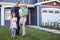 Portrait Of Family Standing Outside House