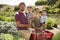 Portrait Of Family Working On Community Allotment Together