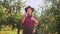 Portrait of farmer in hat showing thumbs to up in the apple garden