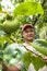 portrait of farmer on peaches fruit orchard