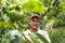 portrait of farmer on peaches fruit orchard