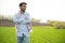 Portrait of farmer standing in a wheat field. farmer stands in green wheat field, looks, examines his crop