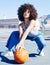 Portrait, fashion and basketball with a black woman outdoor on a sports court for urban or street style. City, fitness