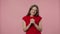 Portrait of fashion model looking at camera with excitement, then celebrating her victory triumph. Young girl in red t