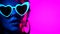 Portrait of fashion model woman with heart shaped glasses in neon light. Fluorescent unusual makeup glowing under UV