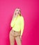 Portrait of fashion smiling blonde model girl young woman wearing stylish  on a pink