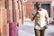 Portrait of fashionable cool black man walking outdoors with cup of coffee