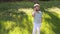 Portrait of a fashionable little boy in sunglasses in a park on green grass.