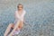 Portrait of a fashionable woman in a dress while beached by the sea