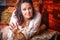 Portrait of fat plump fun charming cute woman with black curly hair in the room with hay and straw