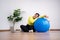 Portrait fat woman rest after exercise with fitness ball in home gym. Overweight woman sitting on a pilates ball and Stretching