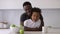 Portrait father hugging mixed son in modern kitchen interior Spbi. happy african american family