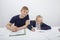 Portrait of father sitting with daughter studying at table