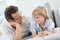 Portrait of father and son lying on sofa talking