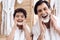 Portrait of father and son with razors which shaving in bathroom.