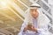 Portrait of feeling strain Arab Middle Eastern Businessman using smartphone in the city background, Success Business concept