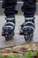 A portrait of feet in rollerblades of a person ready to start an inline skating race on a concrete track