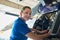 Portrait Of Female Aero Engineer Working On Helicopter In Hangar