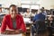 Portrait Of Female Architect With Meeting In Background