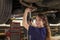 Portrait Of Female Auto Mechanic Working Underneath Car