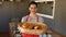 Portrait of female baker holding baguettes in basket