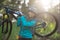 Portrait of female biker carrying mountain bike