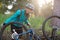 Portrait of female biker repairing mountain bike