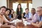 Portrait Of Female Boss With Team In Meeting