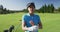 Portrait of female caucasian golf player crossing her arms while standing at golf course