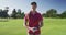 Portrait of female caucasian golf player smiling while standing at golf course